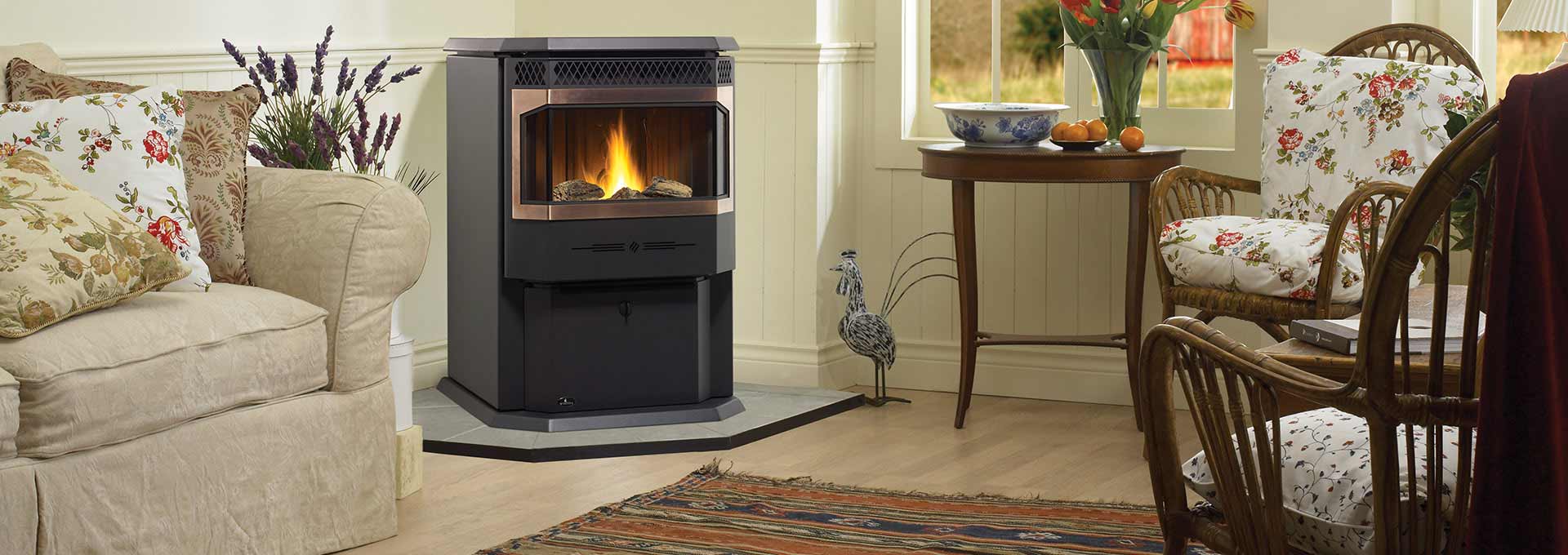 Regency Greenfire GF55 Pellet Stove in black with fire in den with couch and two chairs
