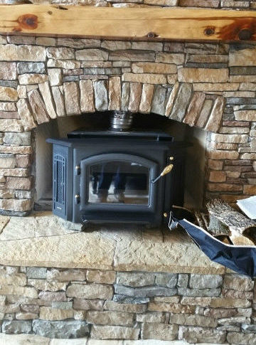 Fireplace insert inside stone mantel