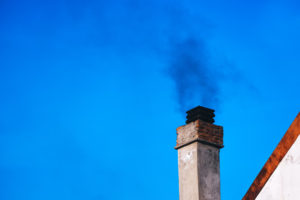 a chimney with smoke coming out