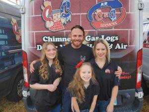 Richard Tattershall, Owner of C&C Chimney in Tulsa, along with his family, including wife and two daughters in front of work van wearing matching company shirts.