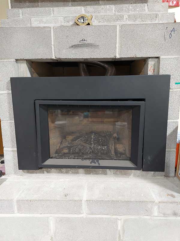 Direct Vent Fireplace insert surrounded by blocks in showroom
