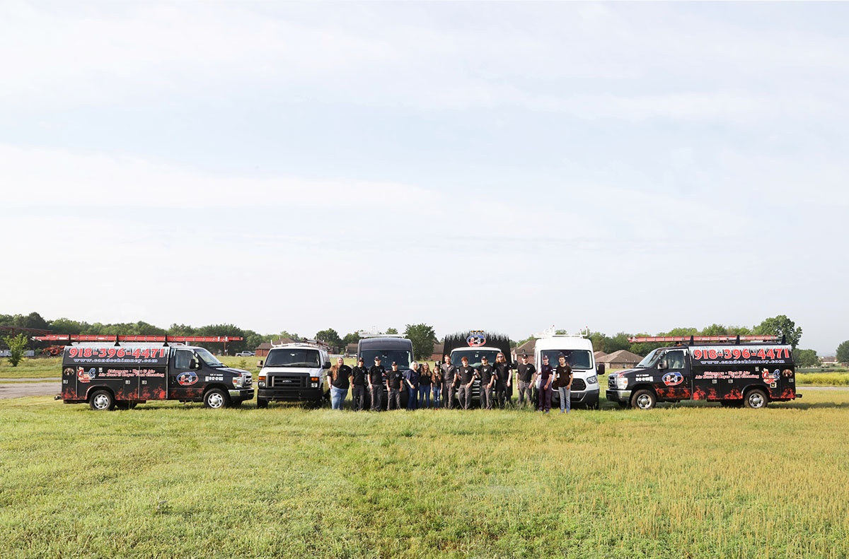Trucks and team members posing in field