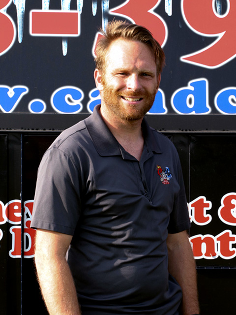 Richard Tattershall owner standing in front of C and C Chimney Logo boards